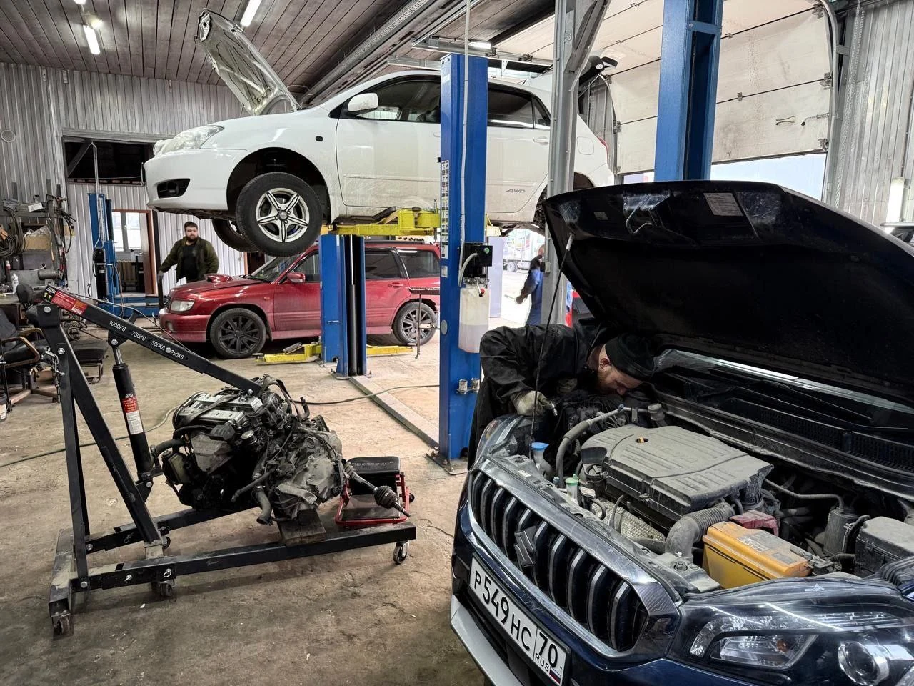 A car being serviced in a garage.